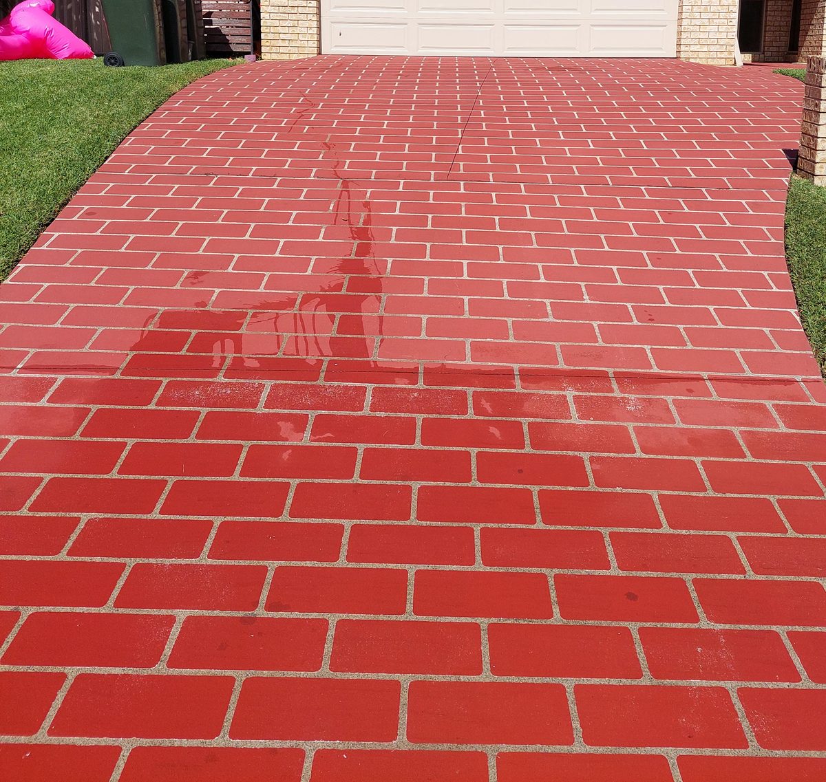 The same paver driveway freshly cleaned and resealed
