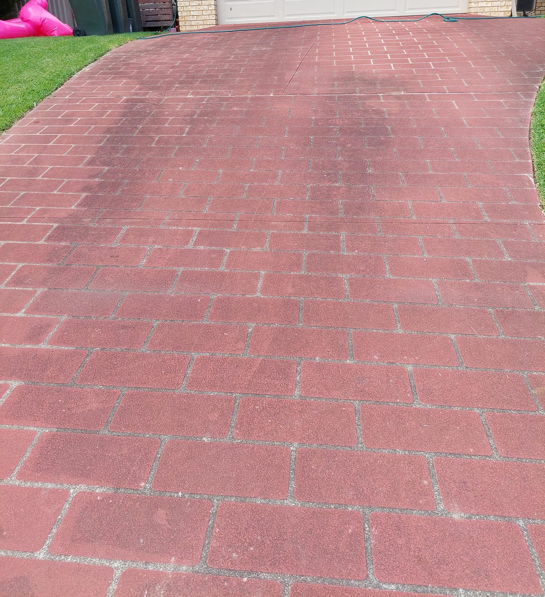 Faded brick paver driveway before pressure cleaning and resealing